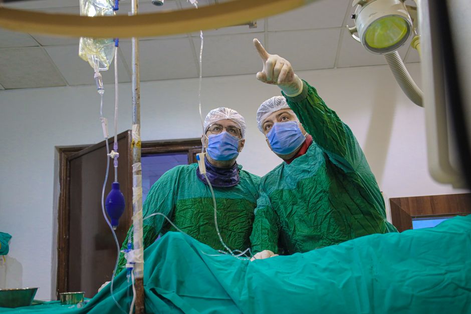 Two surgeons at work in an operating theatre.