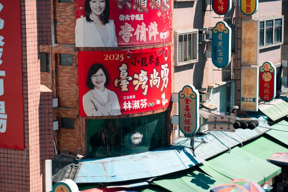 Vibrant street view with billboards in urban Taiwanese setting.