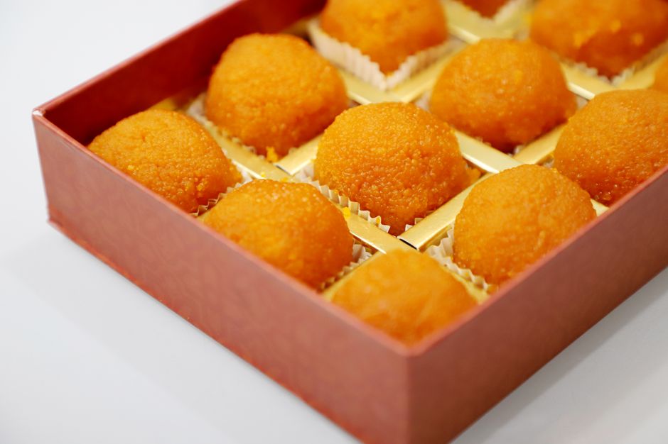 Close-up of Indian laddoo sweets elegantly arranged in a box, perfect for festive treats.